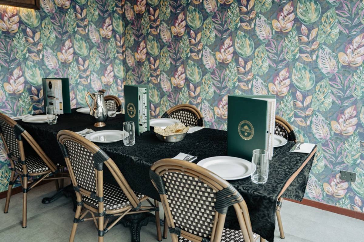 Front Space tables with leaf-print wallpaper